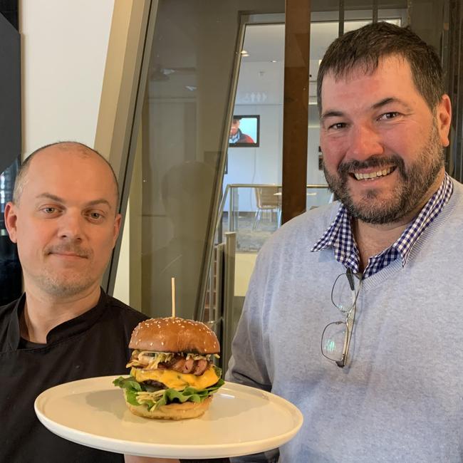 The Griffins Hotel chef Luke Brabin (left) and owner Adam Vonthethoff with their wagyu beef burger. Picture: Sabine Delguste