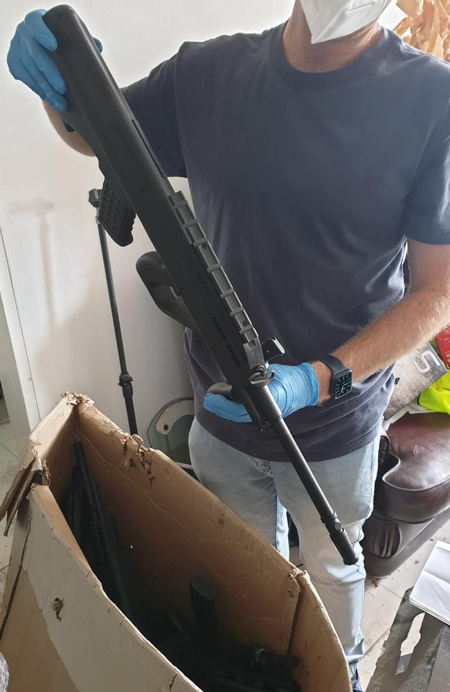 Police with one of the weapons seized in the bust. Picture: NSW Police