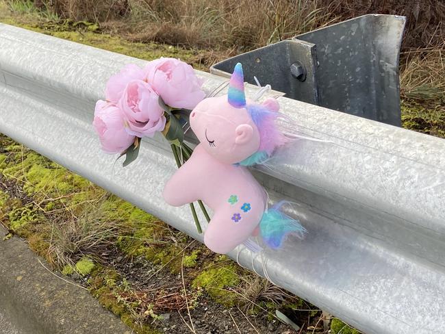 Floral tributes and a small toy unicorn lay at the fatal crash site on Algona Road, where a Huntingfield father and his young daughter were killed in a car crash. Photo: Phil Young