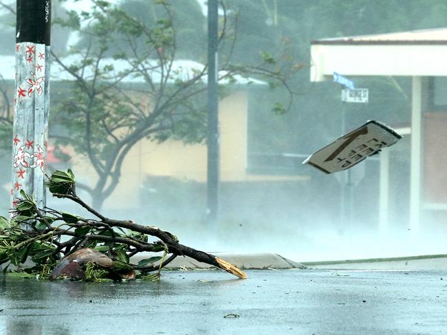 28/3/17: a “keep left” flies past down the street after being ripped from its post as the wind and rain reach their peak as the eye of the cyclone gets closer, in the main street of Bowen. Picture: Lyndon Mechielsen/The Australian