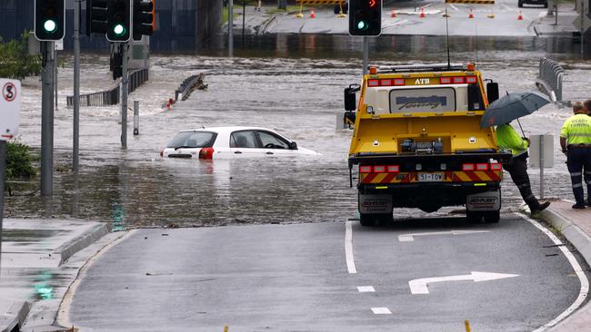 A car is stuck in flood waters in Toombul after heavy rain fell overnight in Brisbane. Picture: Tertius Pickard