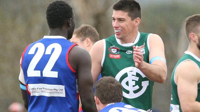 NFL: Greensborough’s Matthew Kreuzer greets Majak Daw of North Heidelberg. Picture: Hamish Blair