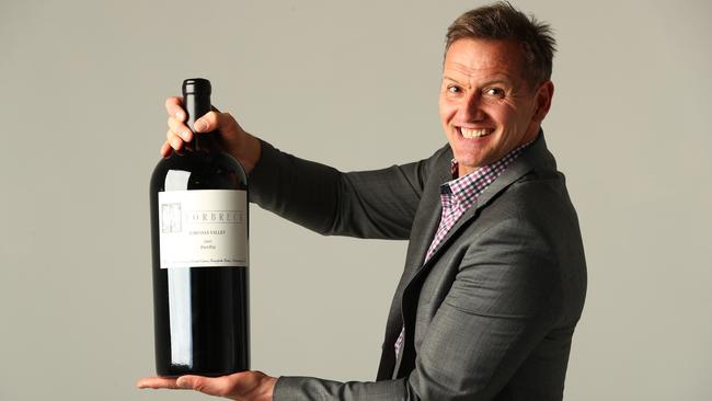 Mark Soderstrom with the 6 litre bottle of wine being auctioned at the Mid Winter Ball. Picture Tait Schmaal.