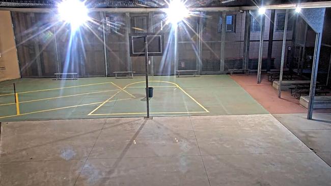 CCTV vision shows a drone dropping contraband into the bucket placed in front of this basketball ring at Parklea jail.