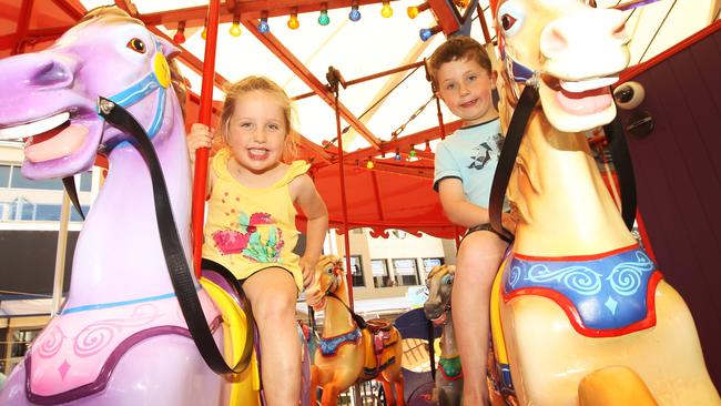 Throughout the decades kids have loved the carousel in the Broadbeach Mall. Taylah Billing (4) and Lachlan Billing (6) enjoy the ride. 