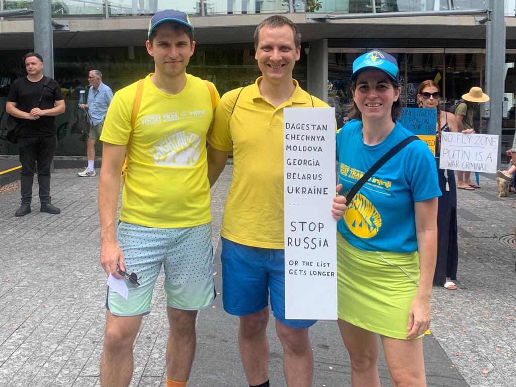 Nancy Lachner, originally from Germany (right) and Markus Kurkela, originally from Finland, (middle) with a friend at a rally hosted by the Ukrainian Community of Queensland in Brisbane on Sunday. Picture: Sarah Petty