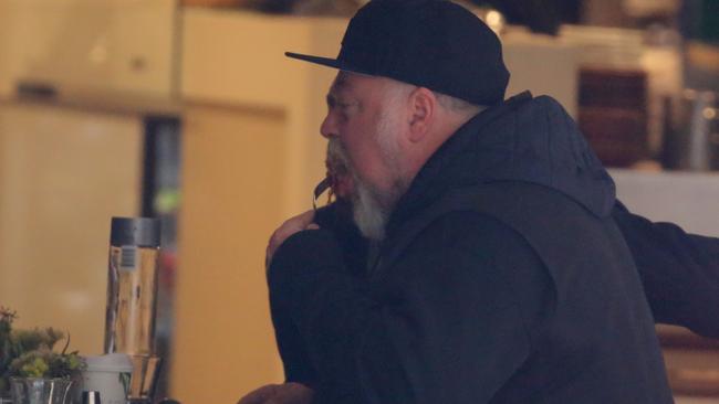 Kyle Sandilands celebrates his recovery with a plate of bacon outside Uliveto Cafe in Kings Cross. Picture: John Grainger