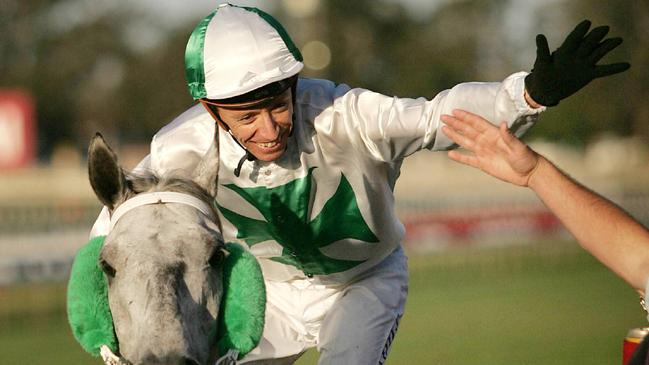 Michael Cahill high fives the crowd on St Basil after winning the 2005 Stradbroke Handicap.