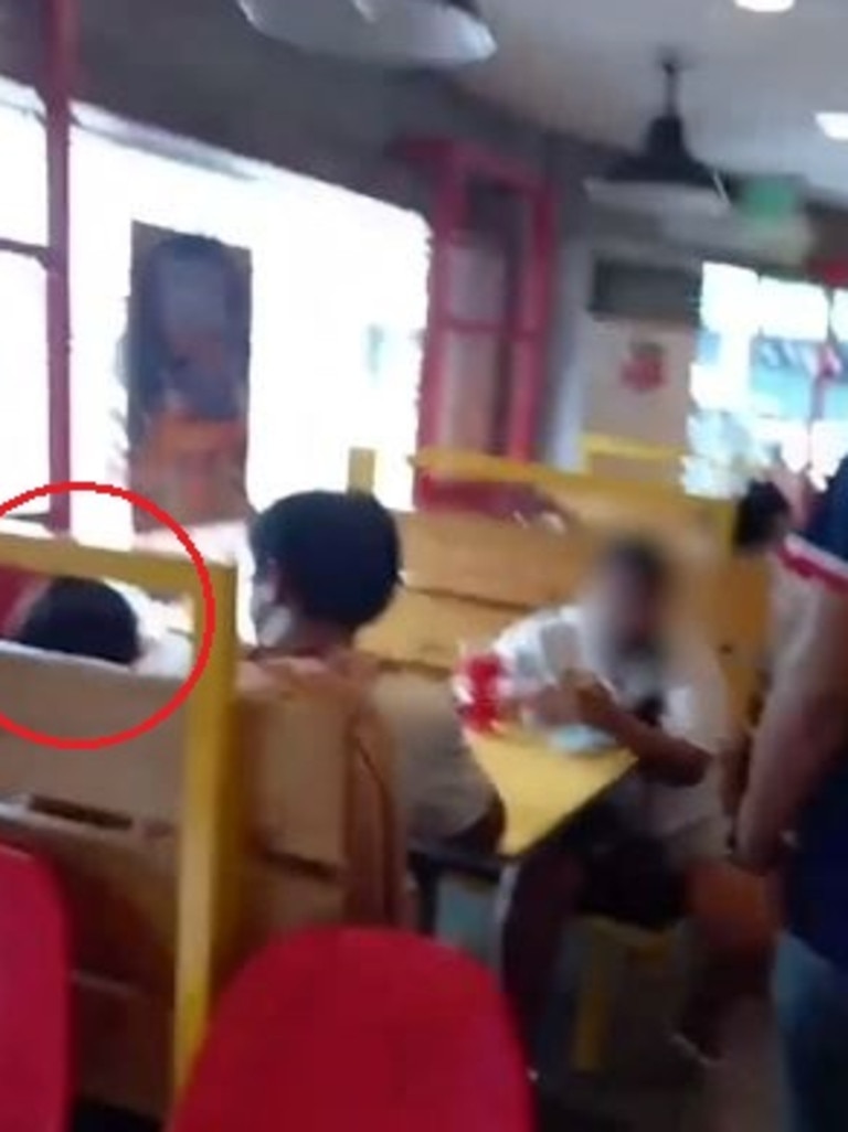 Police footage shows officers approaching the woman, who was with another adult, and the child in a fast food restaurant. Picture: AFP