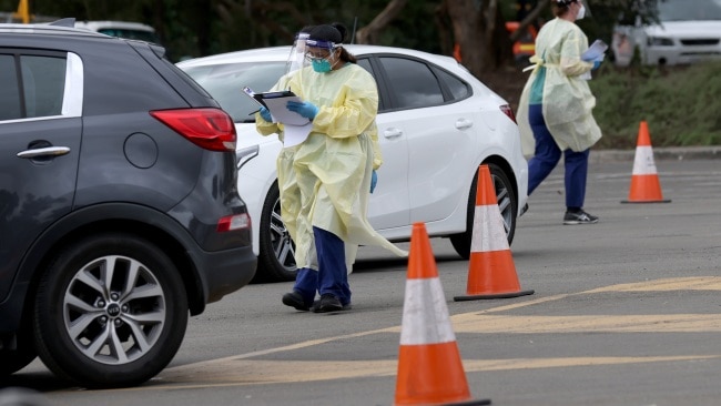 Health workers are seen at a COVID-19 testing site in Adelaide. Picture: Kelly Barnes/Getty Images