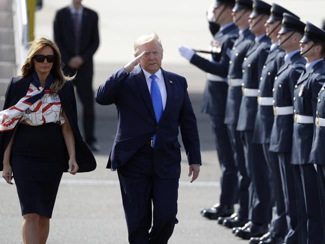 Donald Trump salutes an honour guard as he and first lady Melania Trump arrive at Stansted Airport. Picture: AP