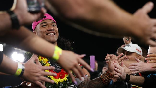 Brian To'o of the Panthers high fives with fans.