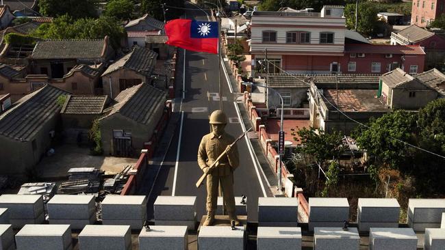 A military statue and Taiwanese flag on top of an arch built in remembrance of the Battle of Guningtou in 1949 at Taiwan's Kinmen islands. Picture: AFP