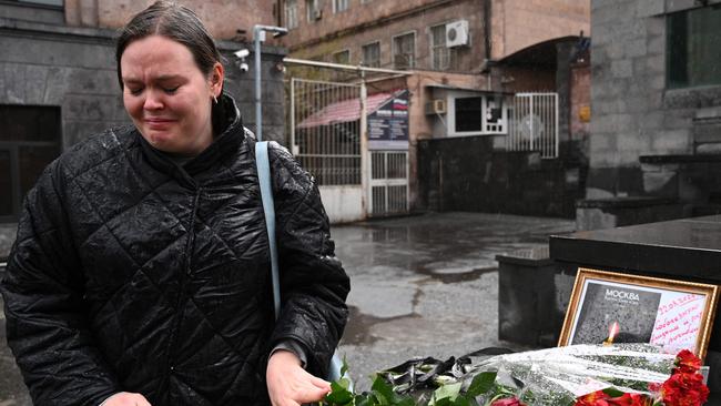 A woman mourns at a makeshift memorial in front of the Russian embassy in Yerevan. Picture: KAREN MINASYAN / AFP