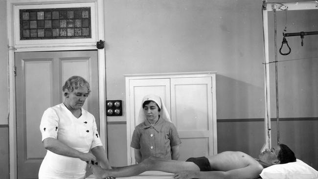 Sister Elizabeth Kenny demonstrating her therapy for polio patients to another nursing sister in 1939. Photo: John Oxley Library, State Library of Queensland