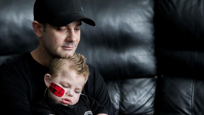 Adam Haevecker poses for a photograph in his Bahrs Scrub home with his one-year-old son Mason. Picture: Richard Walker