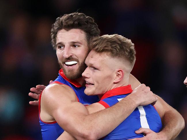 MELBOURNE, AUGUST 2, 2024: 2024 AFL Football - Round 21 - Western Bulldogs V Melbourne Demons at Marvel Stadium. Marcus Bontempelli of the Bulldogs and Adam Treloar of the Bulldogs celebrate goal. Picture: Mark Stewart