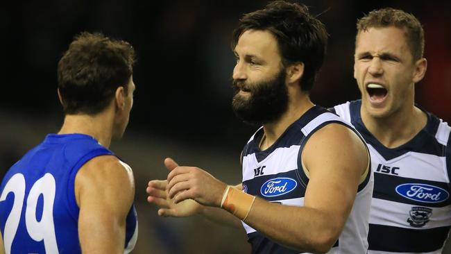 Brent Harvey asks Jimmy for some tips on growing facial hair after a third-quarter goal against the Roos. Picture: Wayne Ludbey