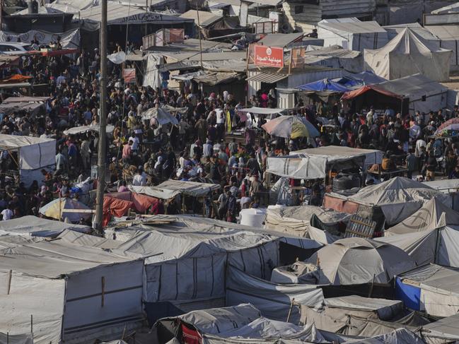 Displaced Palestinians walk trough a makeshift tent camp in Khan Younis, Gaza. Picture: AP