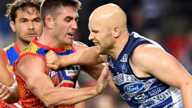 Gary Ablett tussles with Anthony Miles.