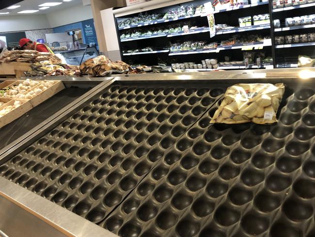 Empty vegetable stands in Coles in South Melbourne. Picture: David Crosling