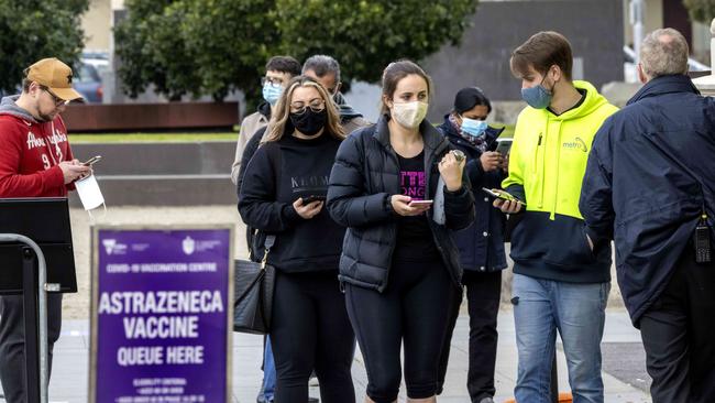 People queue for a Covid vaccination at the vaccination hub at the Exhibition Building in Carlton. Picture: NCA NewsWire / David Geraghty