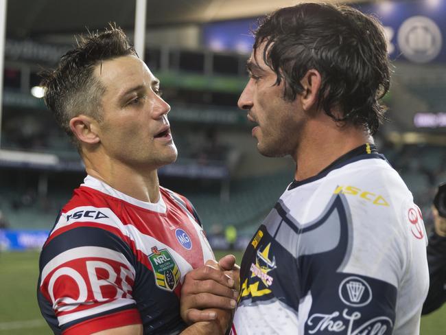 Roosters halfback Cooper Cronk catches up with Johnathan Thurston after the match. Picture: AAP