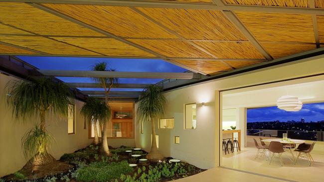 Palm trees between two wings of Mr Huang’s home. Picture: Maccormick &amp; Associates / Huw Lambert.