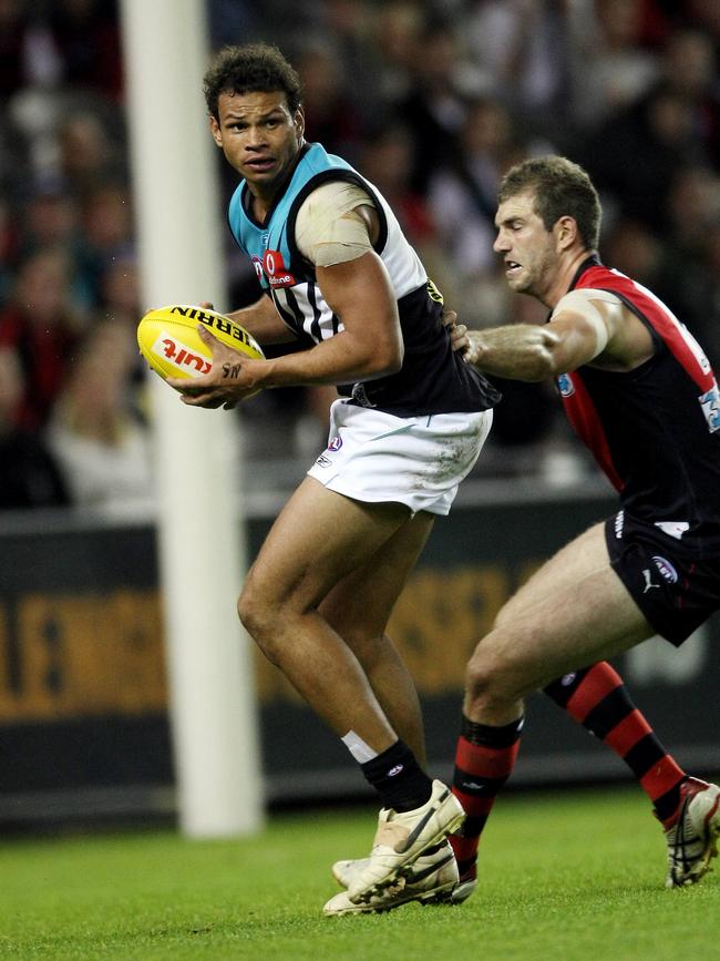 Daniel Motlop turns Essendon’s Jay Nash inside out before kicking one of his seven goals against the Bombers in 2008.