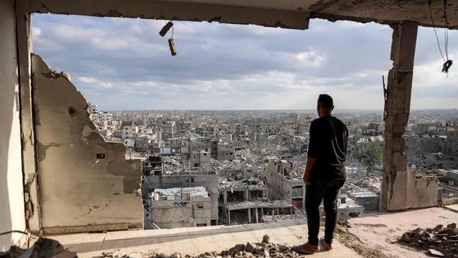 A man standing atop a heavily damaged building views other destroyed buildings in Khan Younis in the southern Gaza Strip on Monday. Picture: AFP