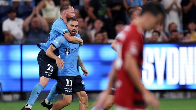 Anthony Caceres is embraced by Sydney FC captain Rhyan Grant after scoring against the Wanderers. Picture: Brendon Thorne/Getty Images