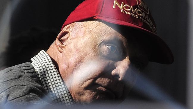 FILE - In this Friday, Feb. 20, 2015 file photo former Austrian Formula One driver Niki Lauda is pictured through a glass window, during the 2015 Formula One testing, at the Barcelona Catalunya racetrack in Montmelo, Spain. Three-time Formula One world champion Niki Lauda, who won two of his titles after a horrific crash that left him with serious burns and went on to become a prominent figure in the aviation industry, has died. He was 70. (AP Photo/Manu Fernandez, File)