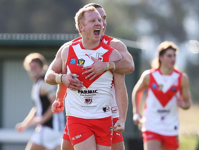 Clarence's Josh Green celebrates with teammates after kicking a goal. Picture: ZAK SIMMONDS