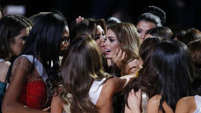 Other contestants comfort Miss Colombia Ariadna Gutierrez, center, after she was incorrectly crowned Miss Universe. Picture: John Locher/AP Photo.