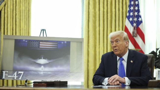 President Donald Trump speaks as an image of an F-47 sixth-generation fighter jet is displayed during an event in the Oval Office. Picture: AP