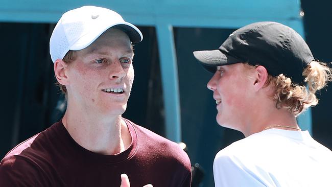 Jannik Sinner and Cruz Hewitt shake hands following a practice session ahead of the 2025 Australian Open. (Photo by Kelly Defina/Getty Images)