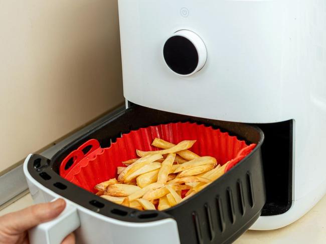 Accessorise your air fryer with these handy liners and attachments for even convenient and mess free cooking. Picture: iStock/herstockart.