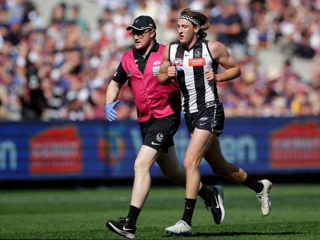 MELBOURNE, AUSTRALIA - SEPTEMBER 30: Nathan Murphy of the Magpies leaves the ground in the hands of a trainer during the 2023 AFL Grand Final match between the Collingwood Magpies and the Brisbane Lions at the Melbourne Cricket Ground on September 30, 2023 in Melbourne, Australia. (Photo by Russell Freeman/AFL Photos via Getty Images)