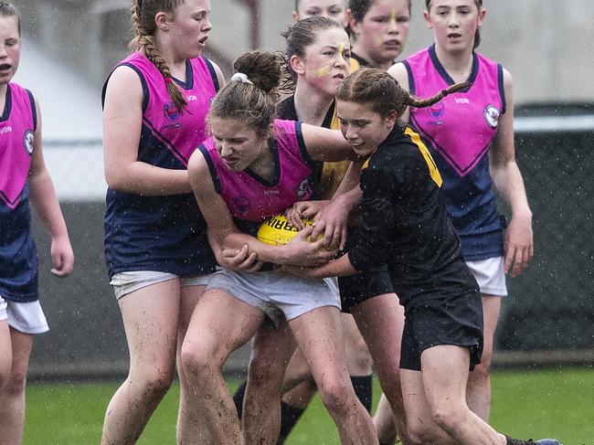 North Hobart’s Mia Anderson is tackled by Kingborough’s Matilda Lange in the under-13 STJFL grand final. Picture: LUKE BOWDEN