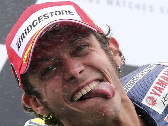 MotoGP rider Valentino Rossi of Italy sprays champagne as he celebrates after winning the Australian Motorcycle Grand Prix at Phillip Island, Australia, Sunday, Oct. 19, 2014.(AP Photo/Rob Griffith)