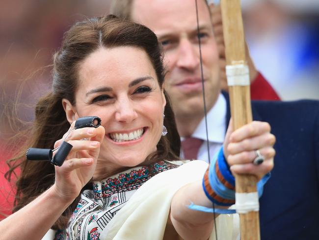 THIMPHU, BHUTAN - APRIL 14: Prince William, Duke of Cambridge looks on as Catherine, Duchess of Cambridge fires an arrow during an Bhutanese archery demonstration on the first day of a two day visit to Bhutan on the 14th April 2016 in Paro, Bhutan. The Royal couple are visiting Bhutan as part of a week long visit to India and Bhutan that has taken in cities such as Mumbai, Delhi, Kaziranga, Bhutan and Agra. (Photo by Chris Jackson/Getty Images)