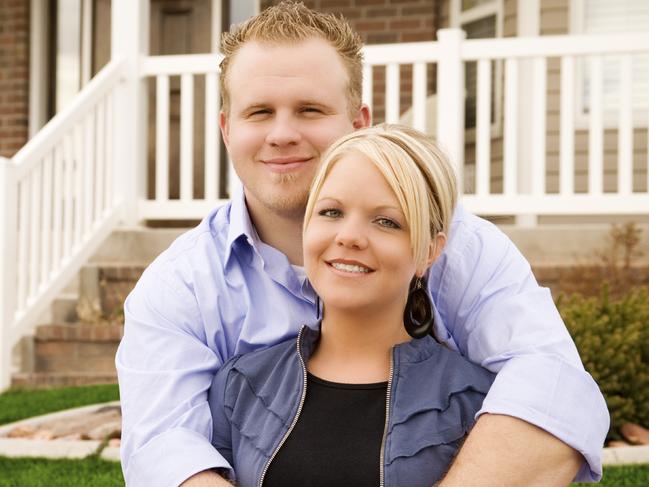 Couple outside a new home and they are paying off their mortgage. Picture: iStock.