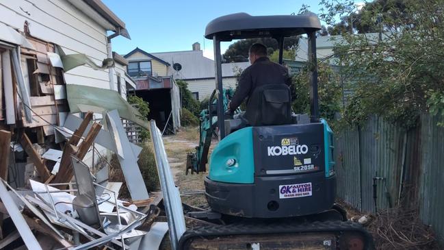 The pair filmed themselves on a hired excavator, ripping down the house.