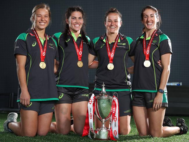 Emma Tonegato, Charlotte Caslick, Shannon Parry and Alicia Quirk at ARU headquarters with their 2018 World Series hardware. Picture: Brett Costello