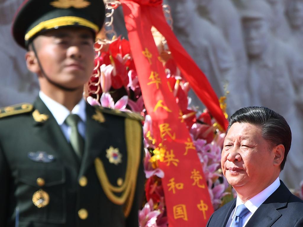 Chinese President Xi Jinping walks past a soldier after laying a wreath at the Monument to the People's Heroes during a ceremony in Beijing's Tiananmen Square, on the eve of National Day on September 30, 2018. - China marks its National Day, the 69th anniversary of the founding of the People's Republic of China, on October 1. (Photo by GREG BAKER / AFP)