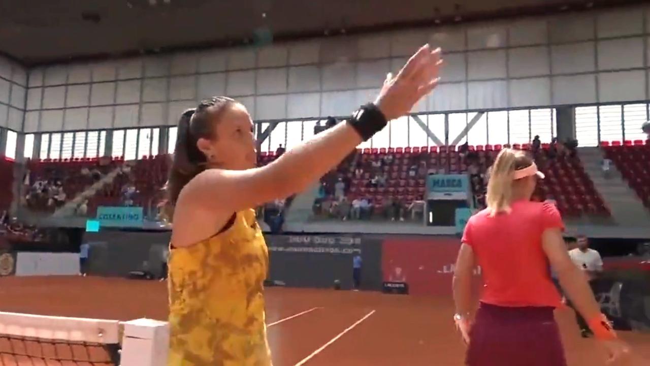 Daria Kasatkina shakes hands with the umpire after Lesia Tsurenko walks past her.