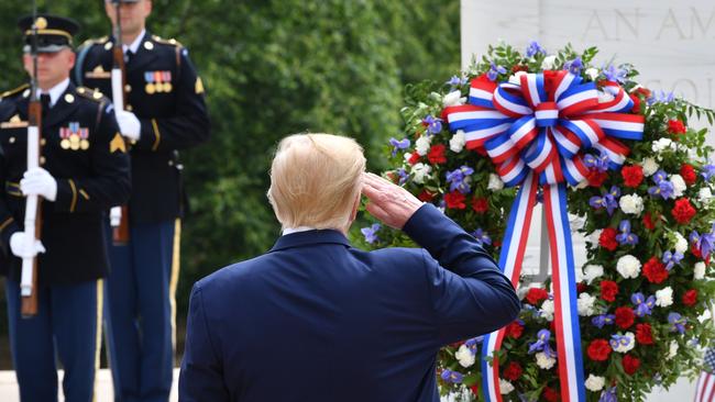 Donald Trump salutes as he participates in a Wreath Laying Ceremony on Memorial Day. Picture: AFP.