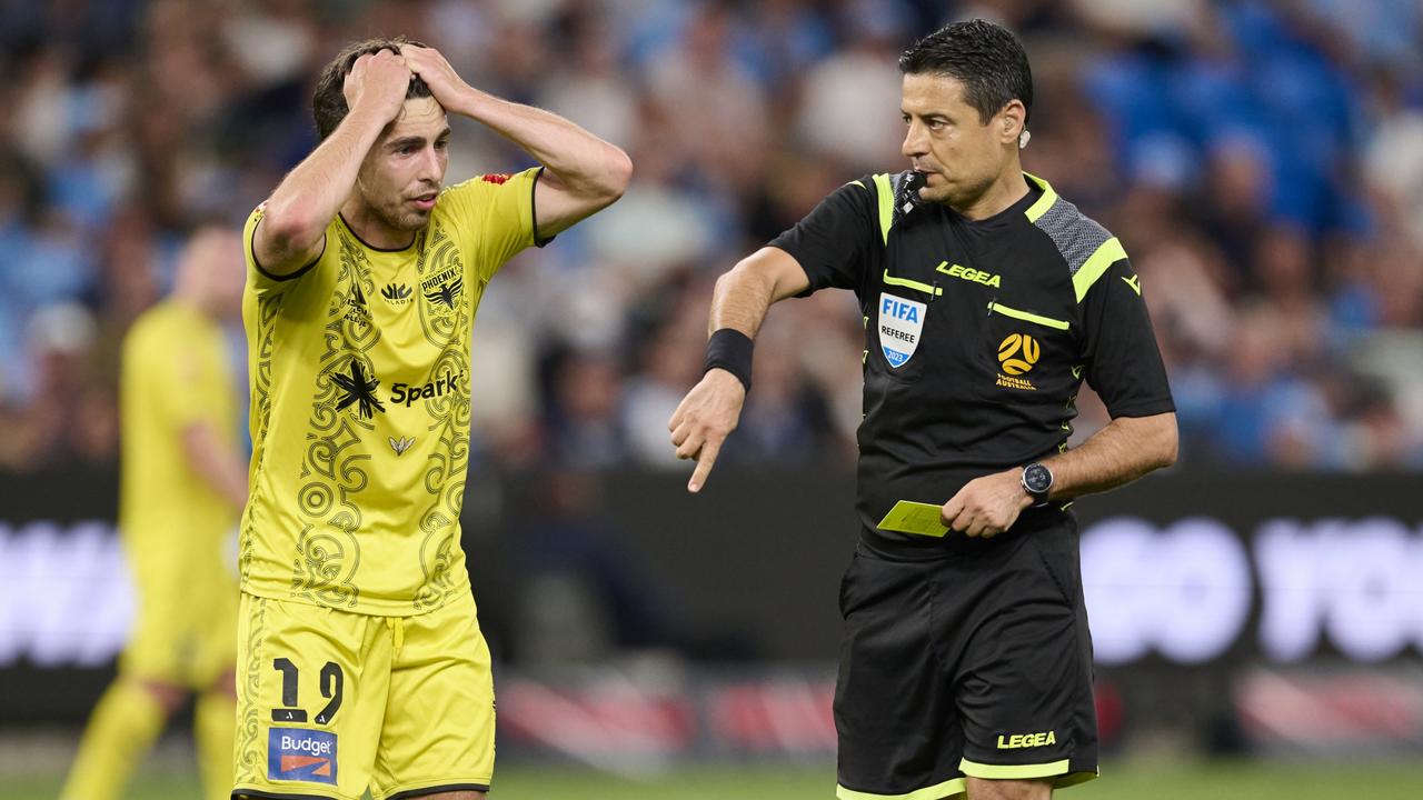 SYDNEY, AUSTRALIA - DECEMBER 29: Sam Sutton of the Phoenix receives a yellow card from Referee Alireza Faghani during the A-League Men round 10 match between Sydney FC and Wellington Phoenix at Allianz Stadium, on December 29, 2023, in Sydney, Australia. (Photo by Brett Hemmings/Getty Images)