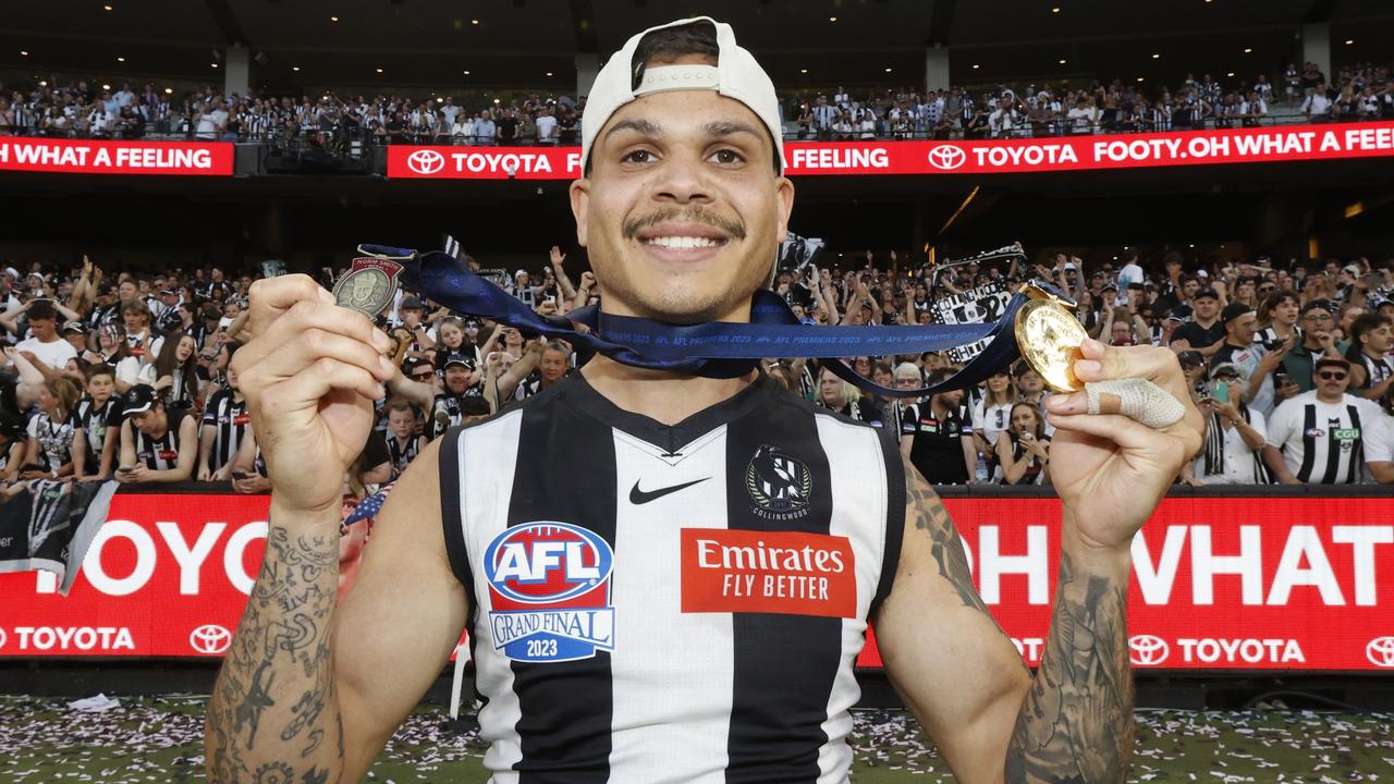 Magpie Bobby Hill holds his North Smith and Premiership medals. Picture: Darrian Traynor