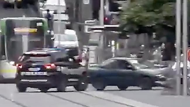 A green car being pursued by police crashes into a bollard in the Bourke Street Mall on January 28.